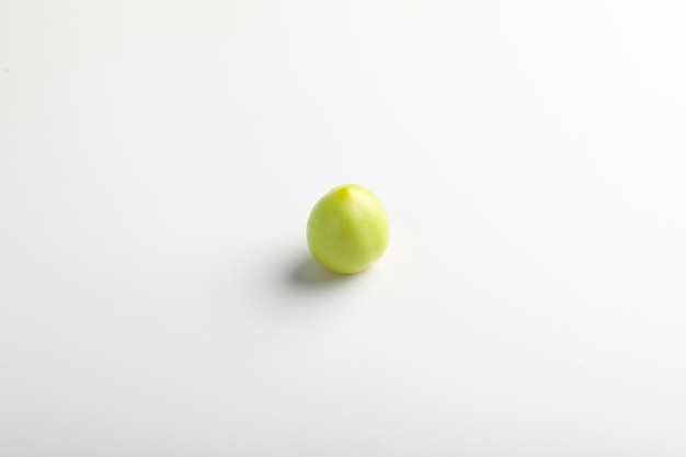 Green tomato on white background