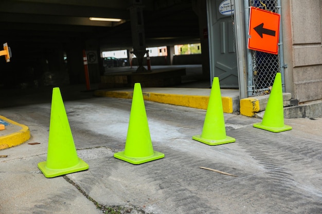 A green traffic cone with an arrow pointing to the right.