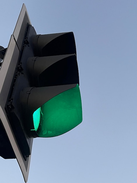 Green traffic lights against blue evening sky