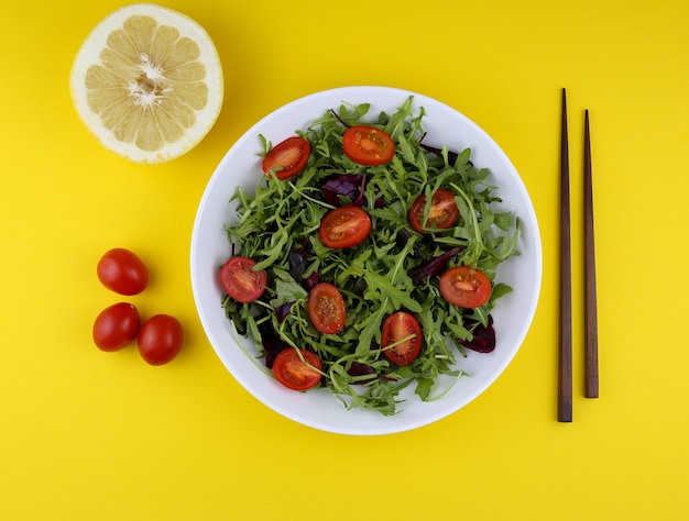 green vegan salad from green leaves mix and tomatoes