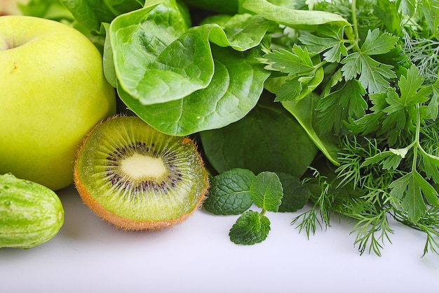 Green vegetables apple, spinach, kiwi, cucumber, parsley, dill and mint. ingredients for smoothies