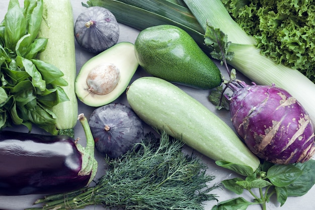 Green and violet vegetables as background