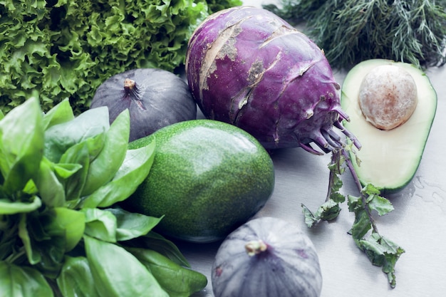 Green and violet vegetables as background