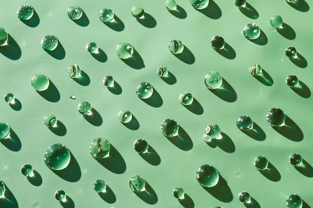 Green water drops on a metal surface as a background texture pattern