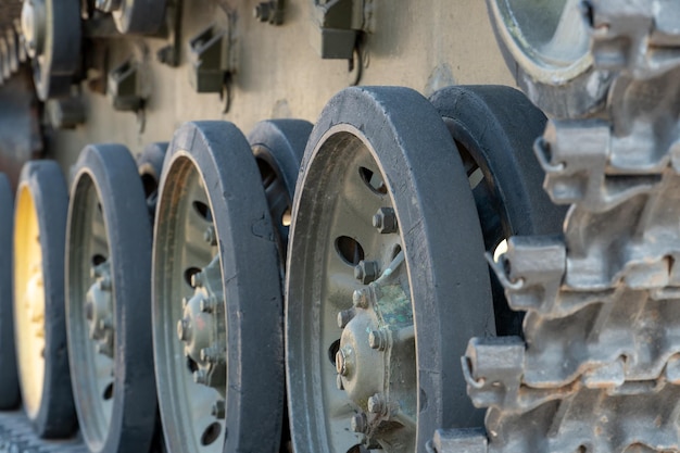 Green wheels and tracks of old military equipment tanks artillery installations and antitank selfpropelled vehicles closeup A tank at an exhibition of old equipment from the Second World War