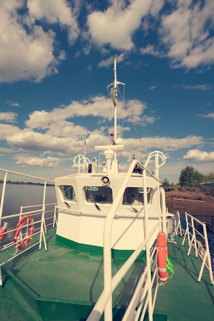 Green and white fishing trawler or boat afloat Sunny toned