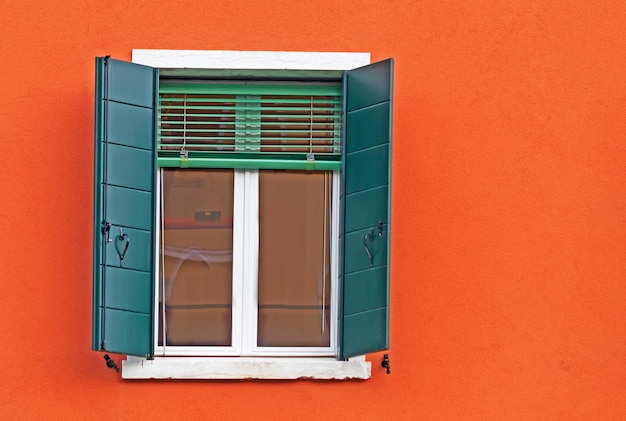 Green window in an orange wall