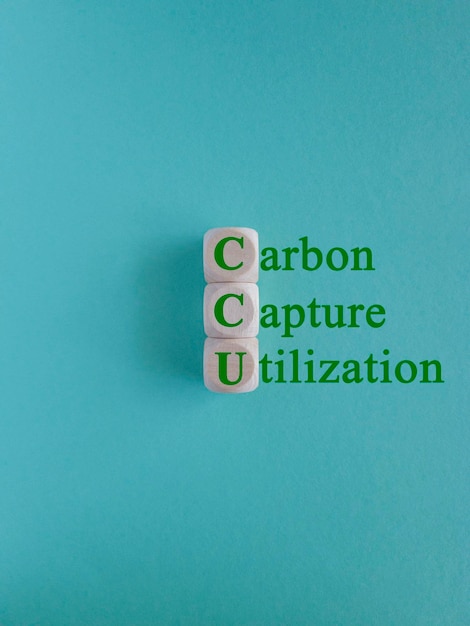 Photo green words carbon capture and utilization written on wooden cubes on blue background