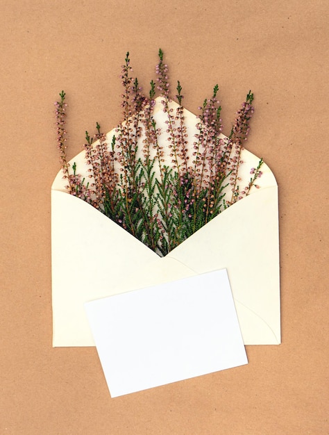 Greeting autumn card with a bouquet of heather in an envelope