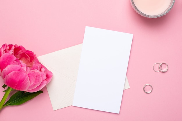 Greeting card with a beautiful flower peony and rings