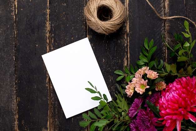 Greeting card with a bouquet of flowers on a dark vintage wood