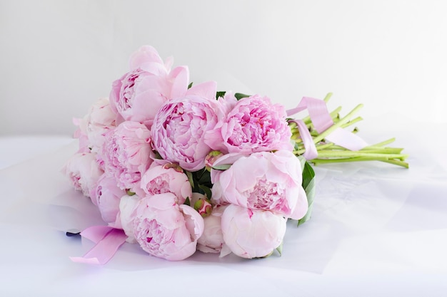 Greeting card with a bouquet of pinks beautiful huge peonies