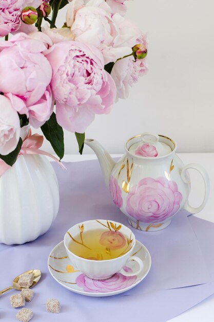 Greeting card with a bouquet of pinks beautiful huge peonies