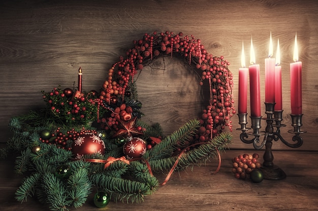 Greeting card with gaultheria, poinsettia and Christmas decorations on wood