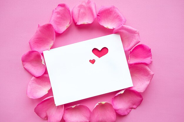 Photo greeting card with heart in rose petals valentines day or weeding concept