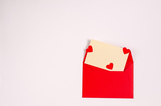 Greeting card with a red envelope with romantic hearts