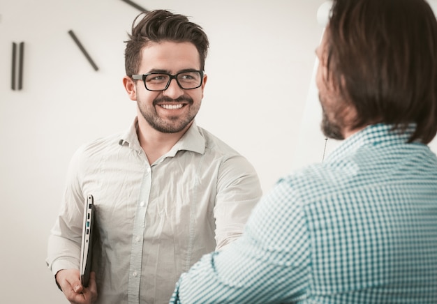 Greeting colleagues shaking hands