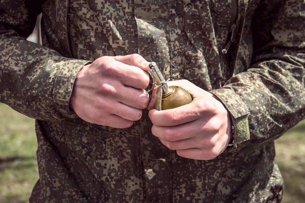 Grenade Hands on Pin the soldier pulls a check from a fragmentation grenade RGD5 Selfexplosion