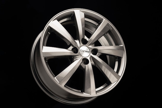 Grey alloy wheel, modern auto parts. black background.