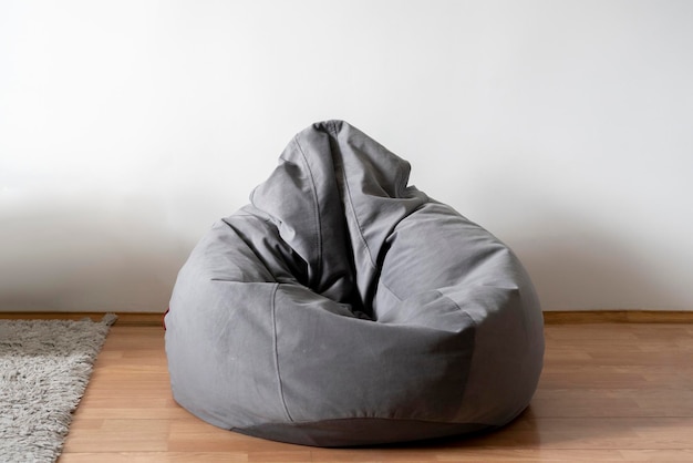 A grey bag chair or bean armchair at home in living room