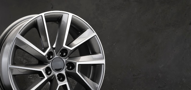 Grey beautiful stylish alloy wheel details on a dark background copy space autotuning