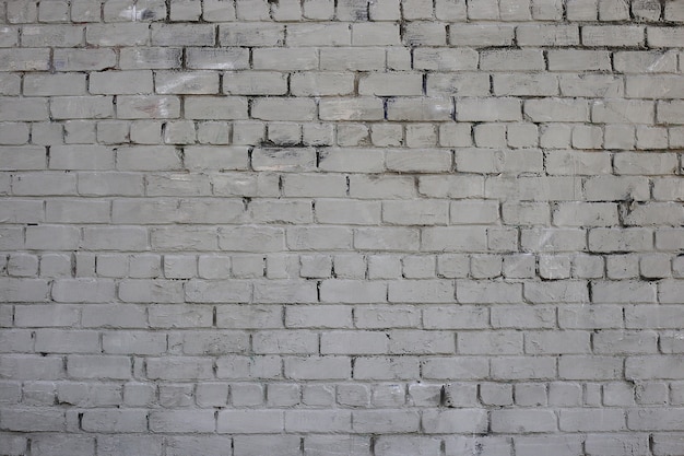 Grey brick wall Weathered texture stained old paint grey brick wall Colored brick wall background