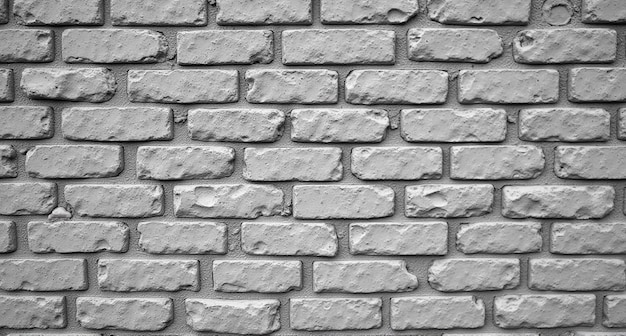 a grey brick wall with a white brick that has a white brick background