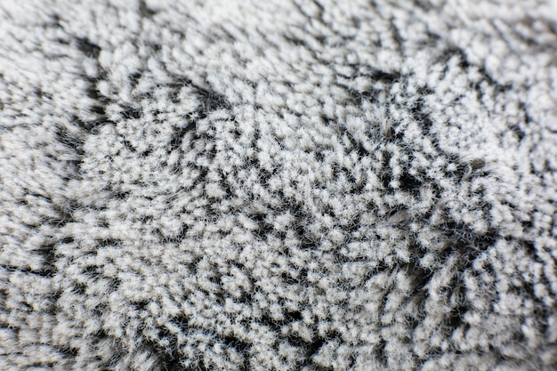 Photo grey cotton towel or carpet
fluffy texture background. close up, macro photo. soft focus image.