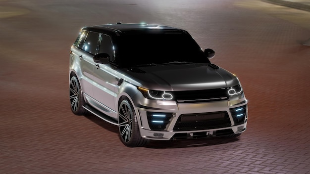 A Grey Luxury SUV Car in blue lagoon at night. Top Front view