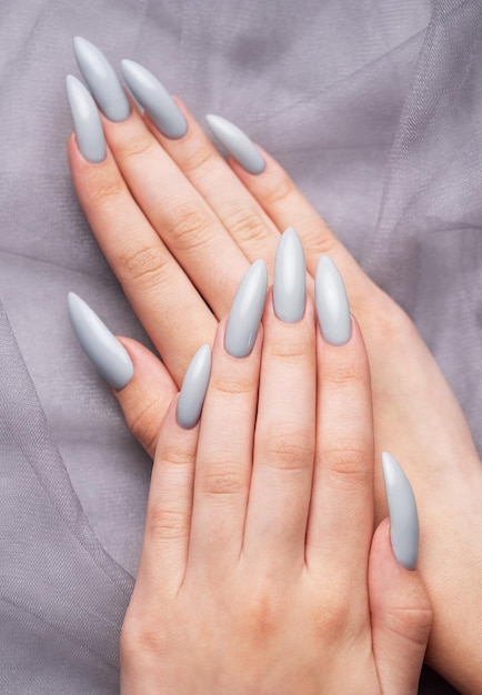 Grey nails on grey lace background