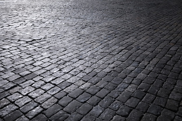 Grey paving stone, pedestrian walkway, pavement close up, the texture, top view.Cement brick squared stone floor background. Concrete paving slabs. Paving slabs