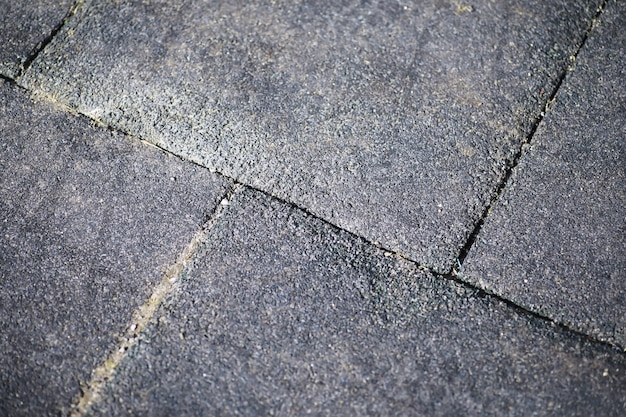 Grey paving stone, pedestrian walkway, pavement close up, the texture, top view.Cement brick squared stone floor background. Concrete paving slabs. Paving slabs