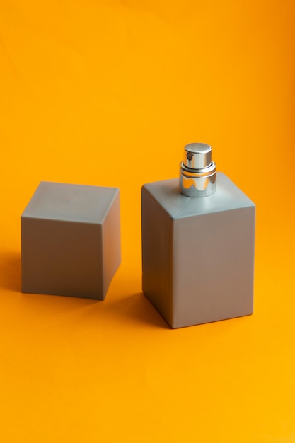 Photo grey perfume bottle on paper background