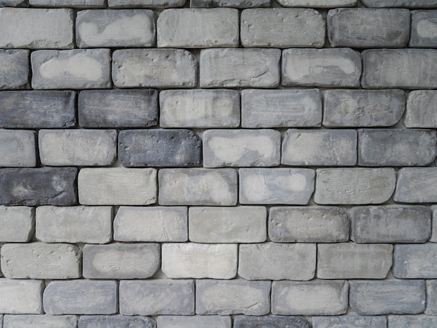 Grey square brick tiles wall texture background, minimal exterior backdrop