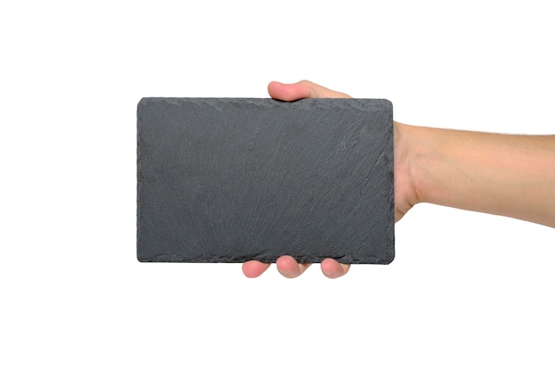 Grey stone slate cutting board with an empty space for text in hand on white background