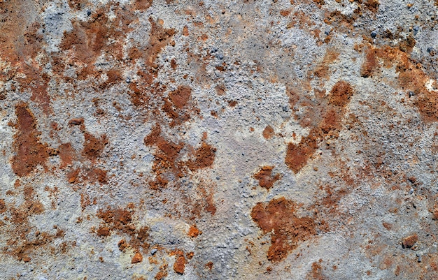 Photo grey stone texture with spots of rust. abandoned industrial background