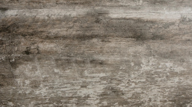 Photo grey wooden background of weathered distressed rustic wood with faded white paint showing woodgrain