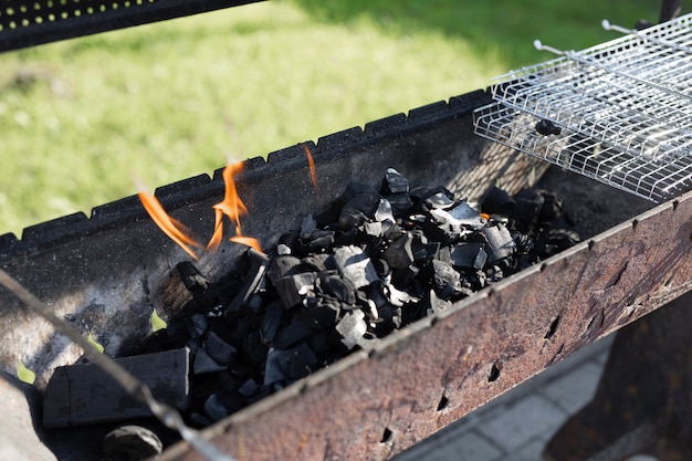 Grill for grilling on the grill with charcoal and fire