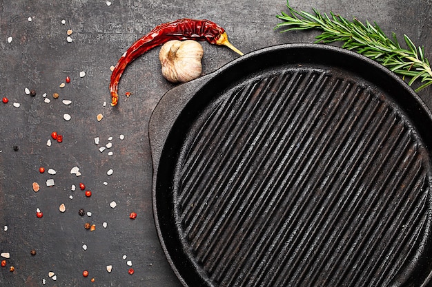 Grill pan and species on old table