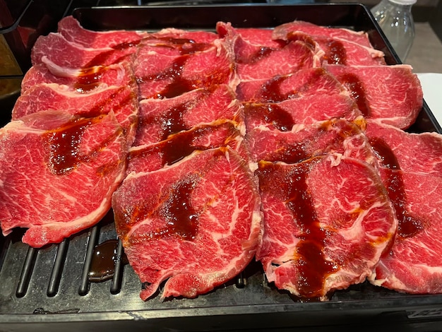 A grill with meat on it and the words " bbq " on the side.