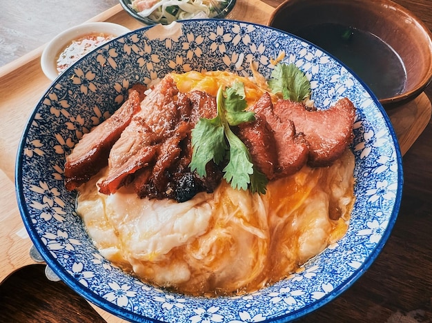 Grilled barbeque pork with egg poach on bowl of rice