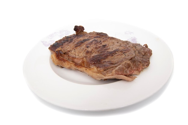 Grilled beef fillet, on a plate, isolated in white background.