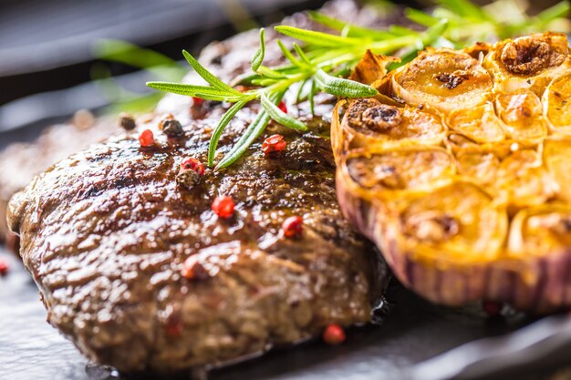 Grilled beef Rib Eye steak with garlic rosemary salt and spices.