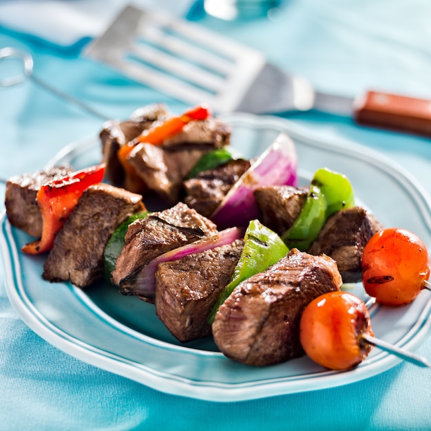 Grilled beef shishkabobs on table