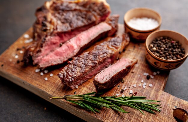 grilled beef steak with spices on a stone