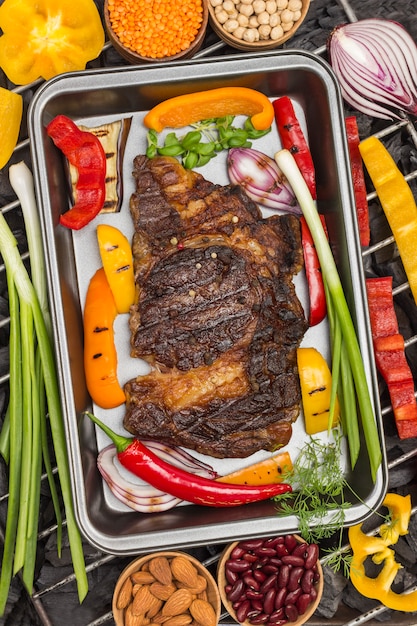 Grilled beef steak with vegetables. Charcoal.