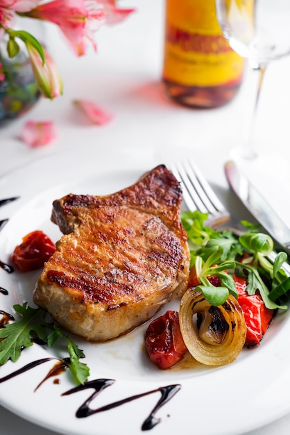 Grilled beefsteaks and vegetables