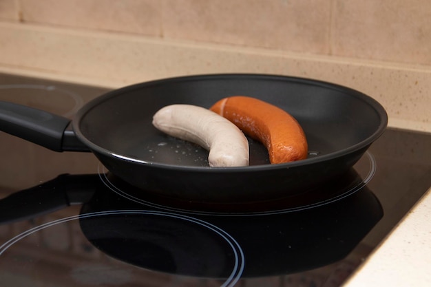 Grilled bratwurst and bockwurst in a pan. Two German sausages. German food concept.