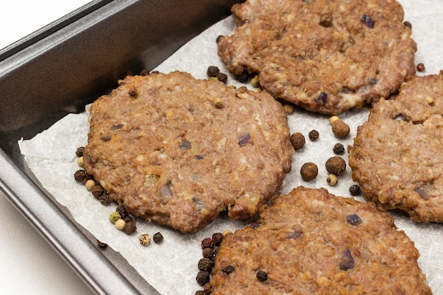 Grilled burgers and allspice on a baking tray