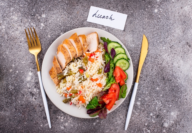 Grilled chicken breast with rice and vegetable